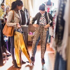 Two young women looking at clothes inside a vintage clothes store in South Africa.