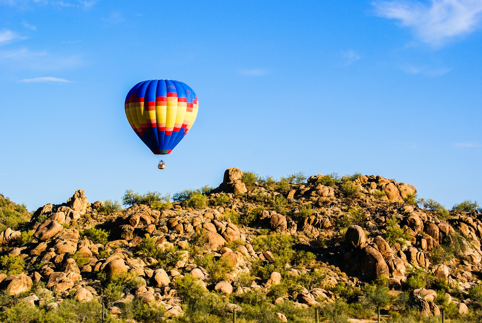 Hot air balloon hovering over the Sonora Dessert with blue sky