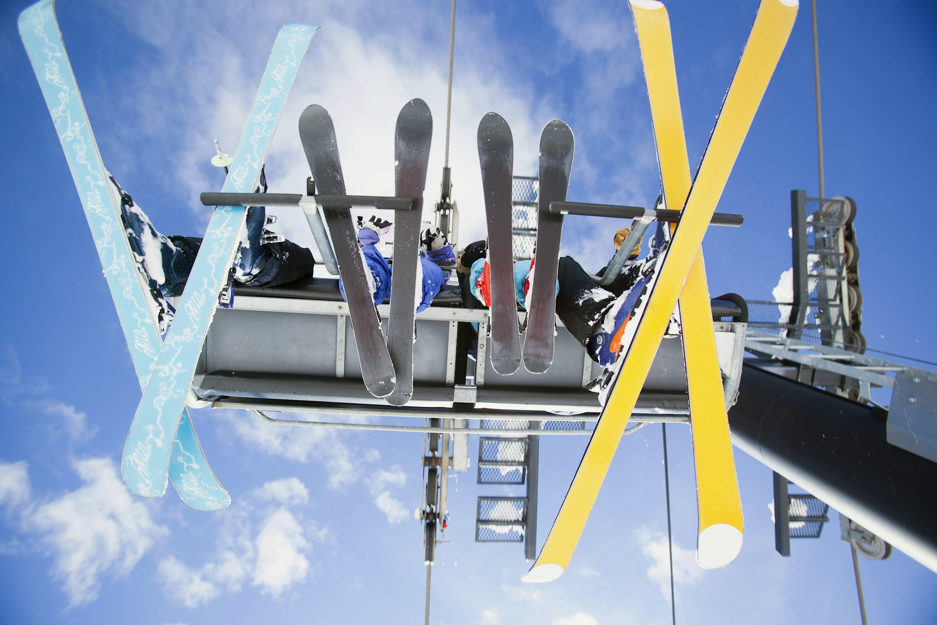 USA, Montana, Whitefish, Family of skiers on ski lift seen from below