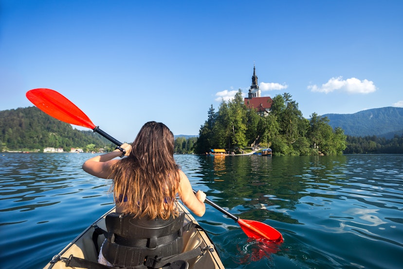 Woman kayaking toward Bled Island.