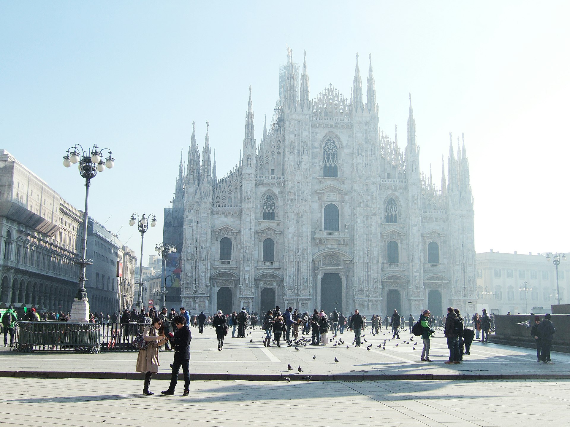Exterior of the Duomo di Milano and Piazza del Duomo with people walking in front