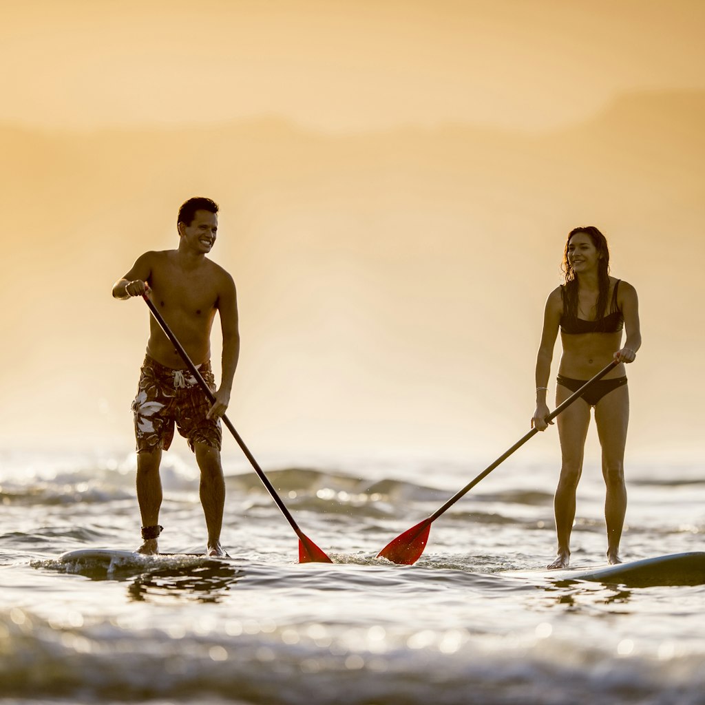 Couple stand up paddleboarding SUP