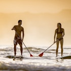 Couple stand up paddleboarding SUP