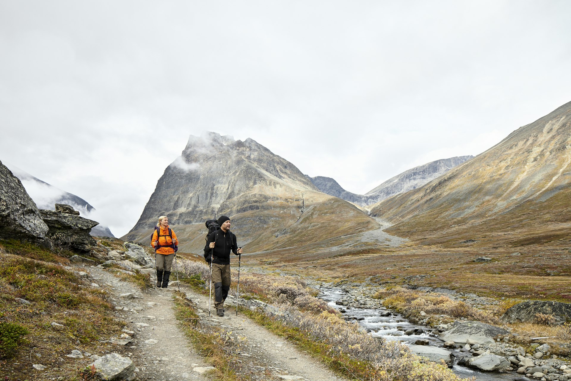 Couple hiking on a mountainous trail through the Jamtland region