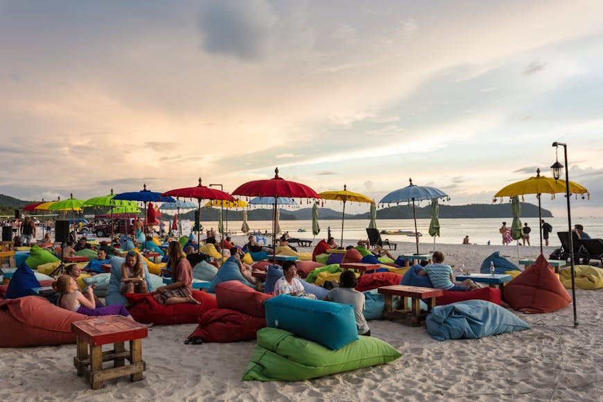 Tourists enjoy a drink at a bar on Cenang beach in Langkawi