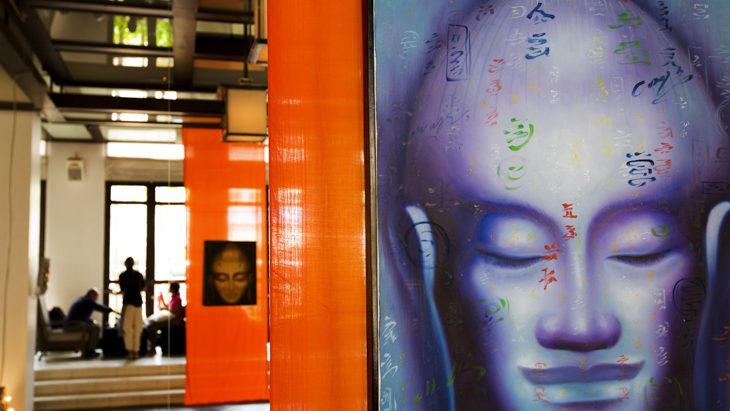 Detail of Buddha head wall painting inside Hotel De La Paix.