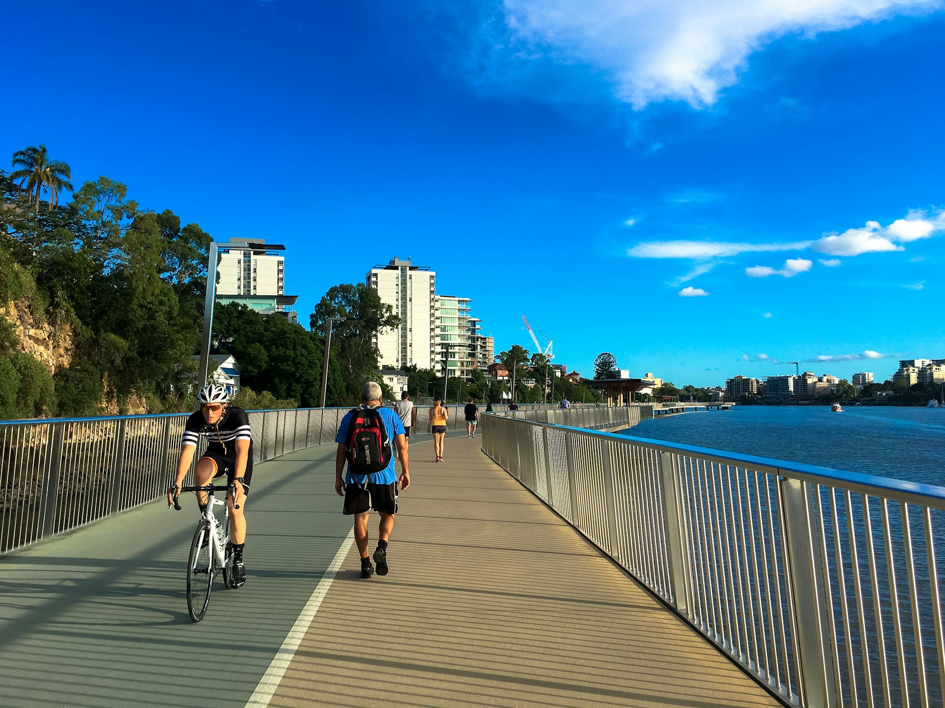 Brisbane Riverwalk with a runner and a cyclist