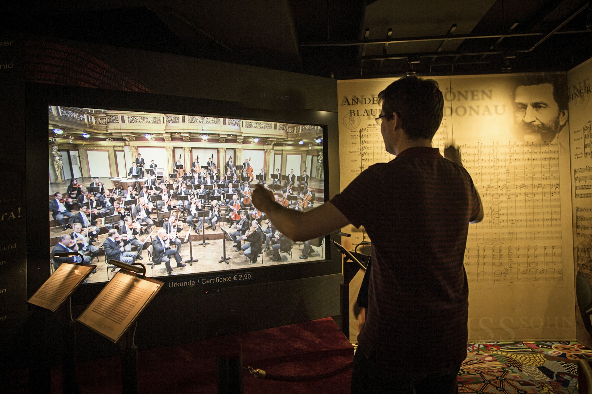 A person conducts a virtual orchestra at Haus der Musik in Vienna