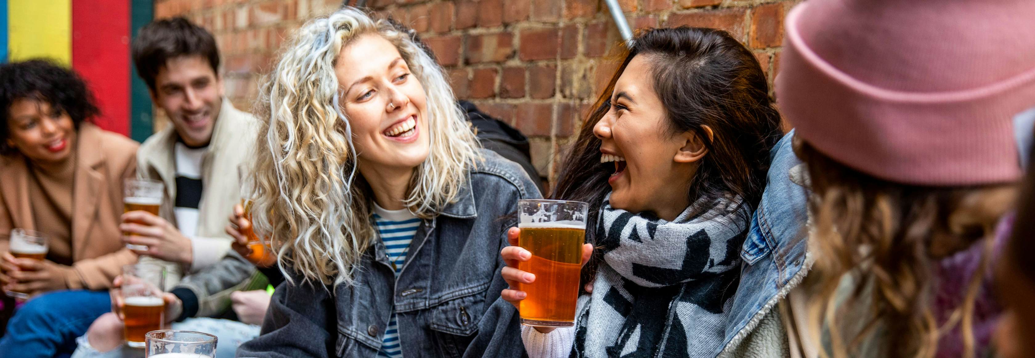 Londoners group of friends meet up in a pub.