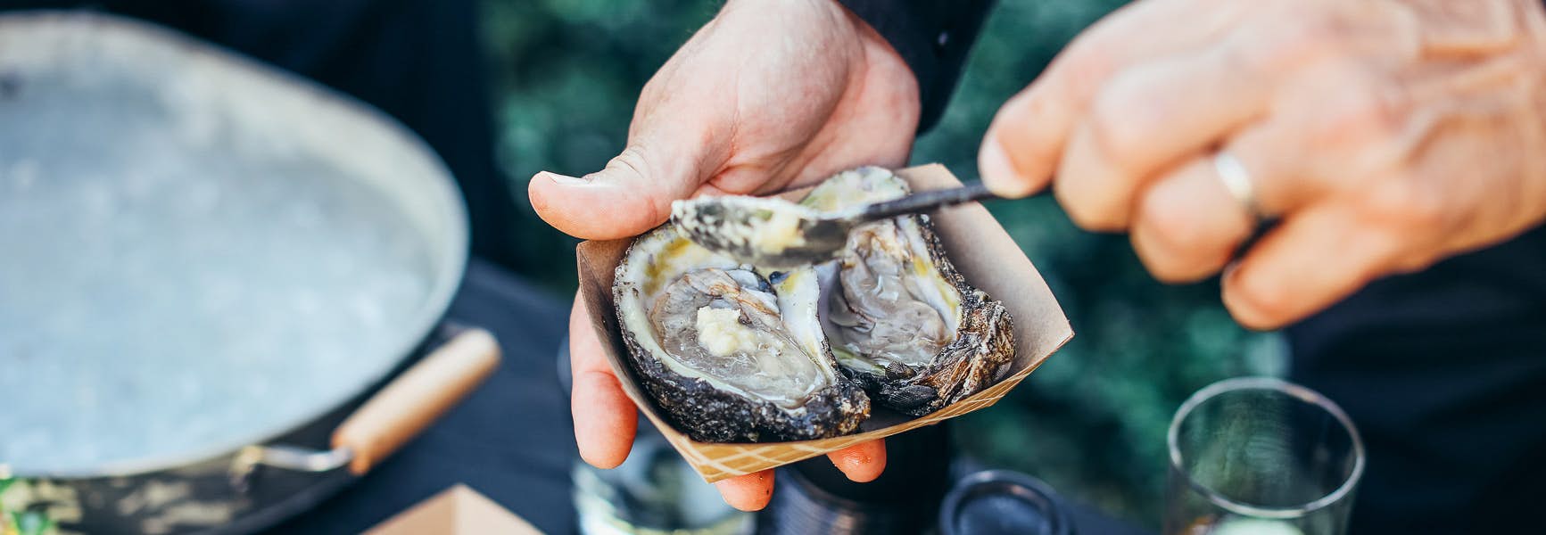 Man preparing oyster to eat