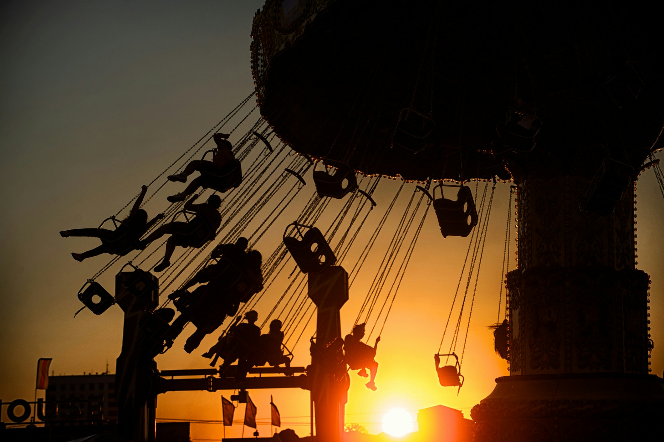 People on a swing ride at sunset at New Mexico's state fair in Albuquerque