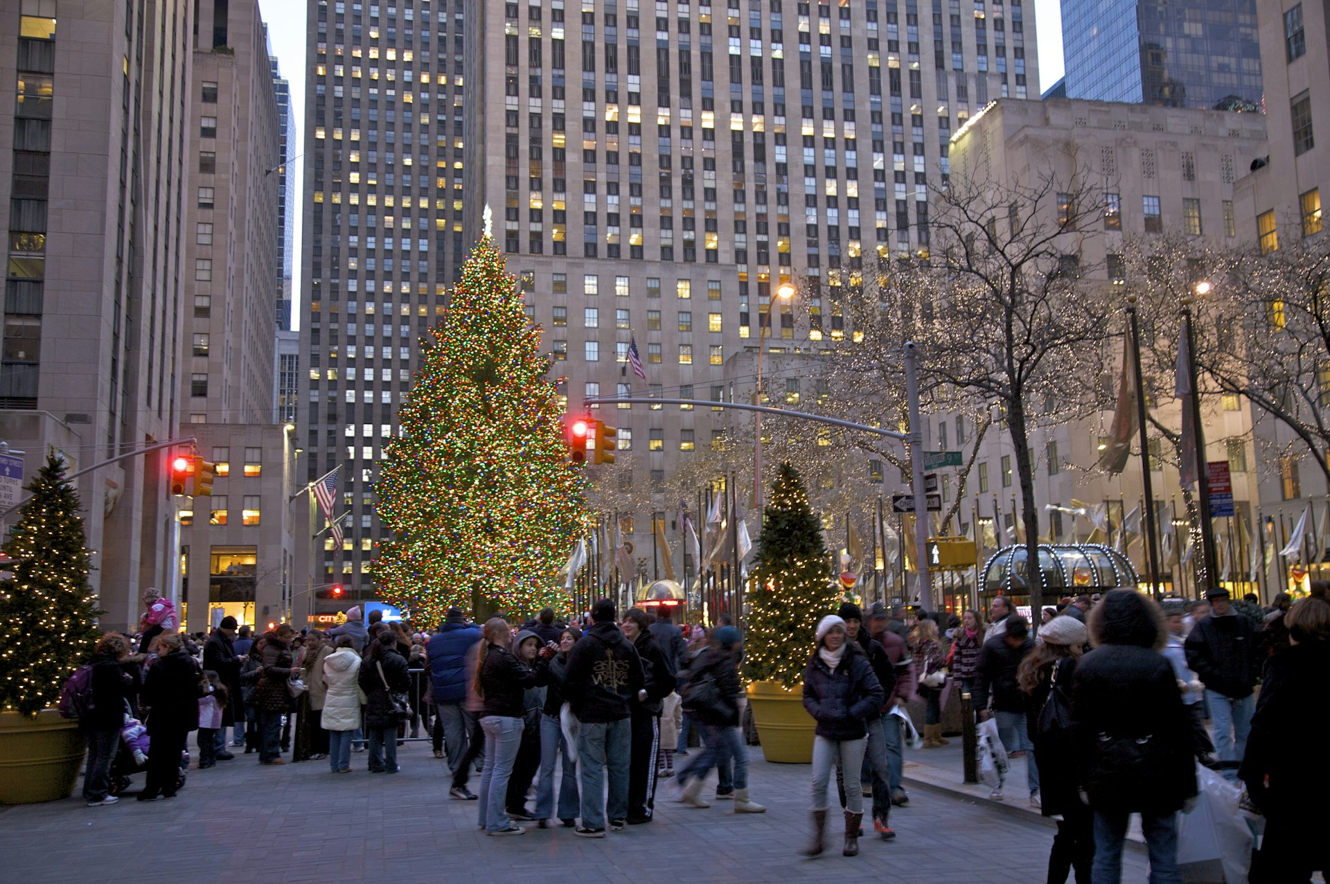 People viewing the Christmas tree at Rockefeller Center at dusk, New York, NY, USA