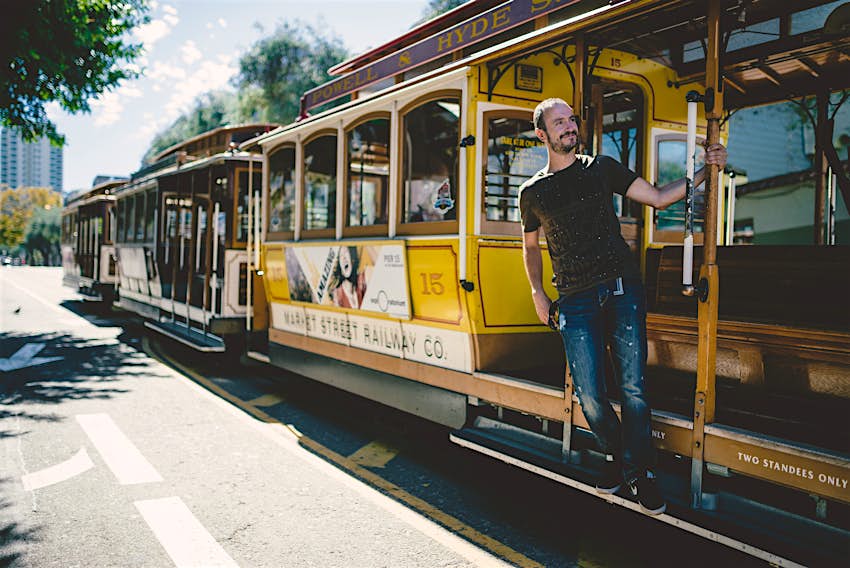 A Caucasian man riding on a cable car