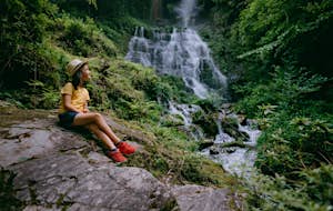 Young girl in forest with waterfall, Kochi, Shikoku, Japan