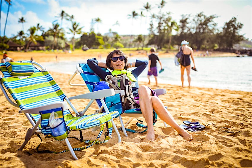 Woman relaxing on a beach in Kauai