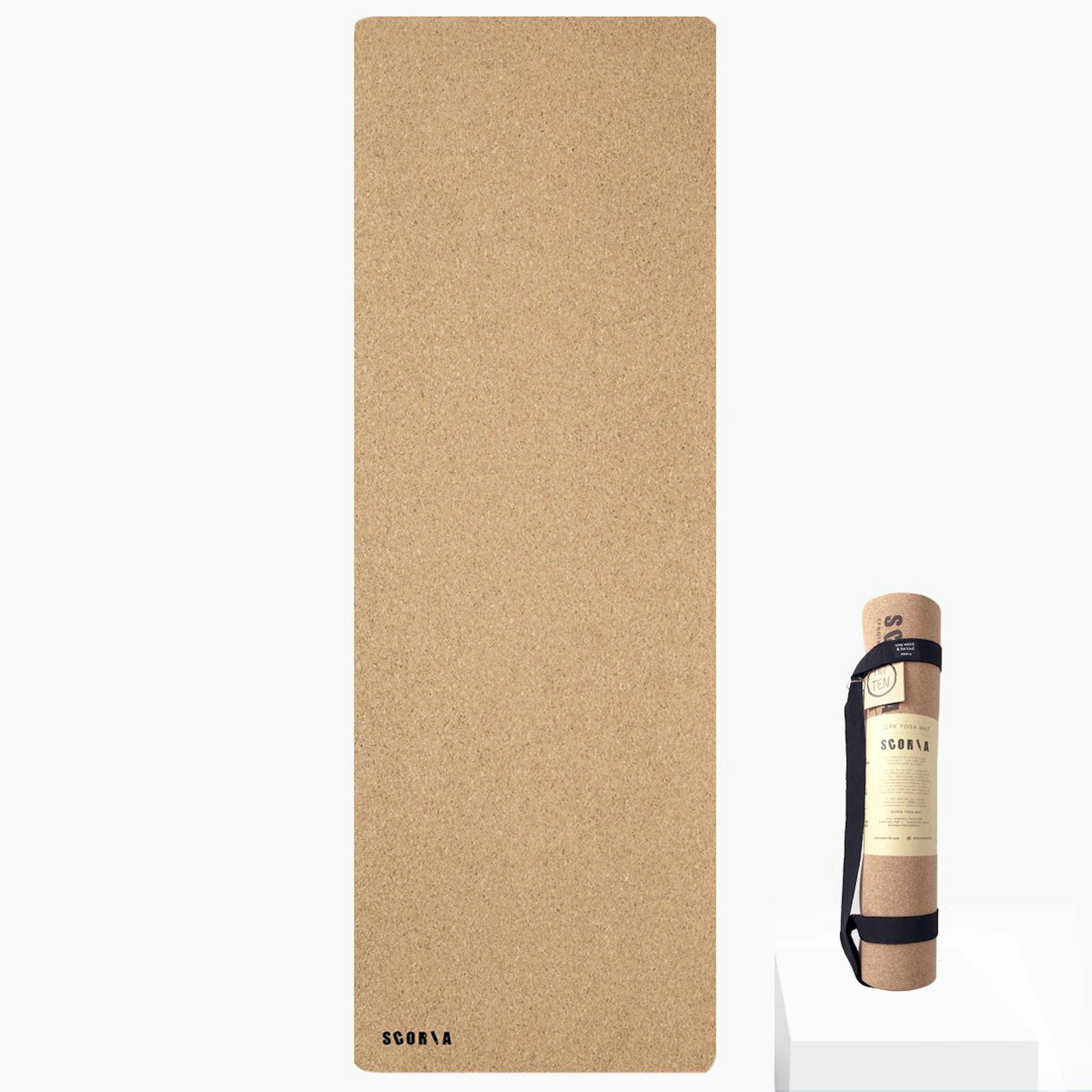 A brown cork yoga mat, seen both unrolled and rolled up