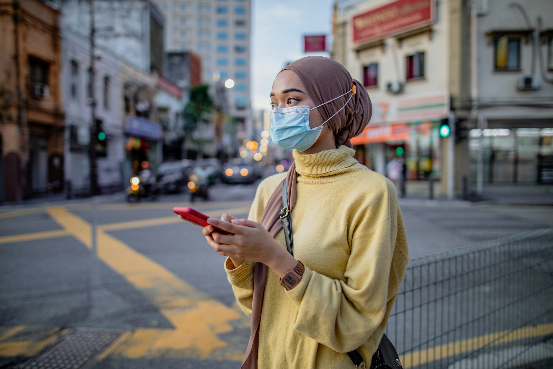 Young asian girl using phone