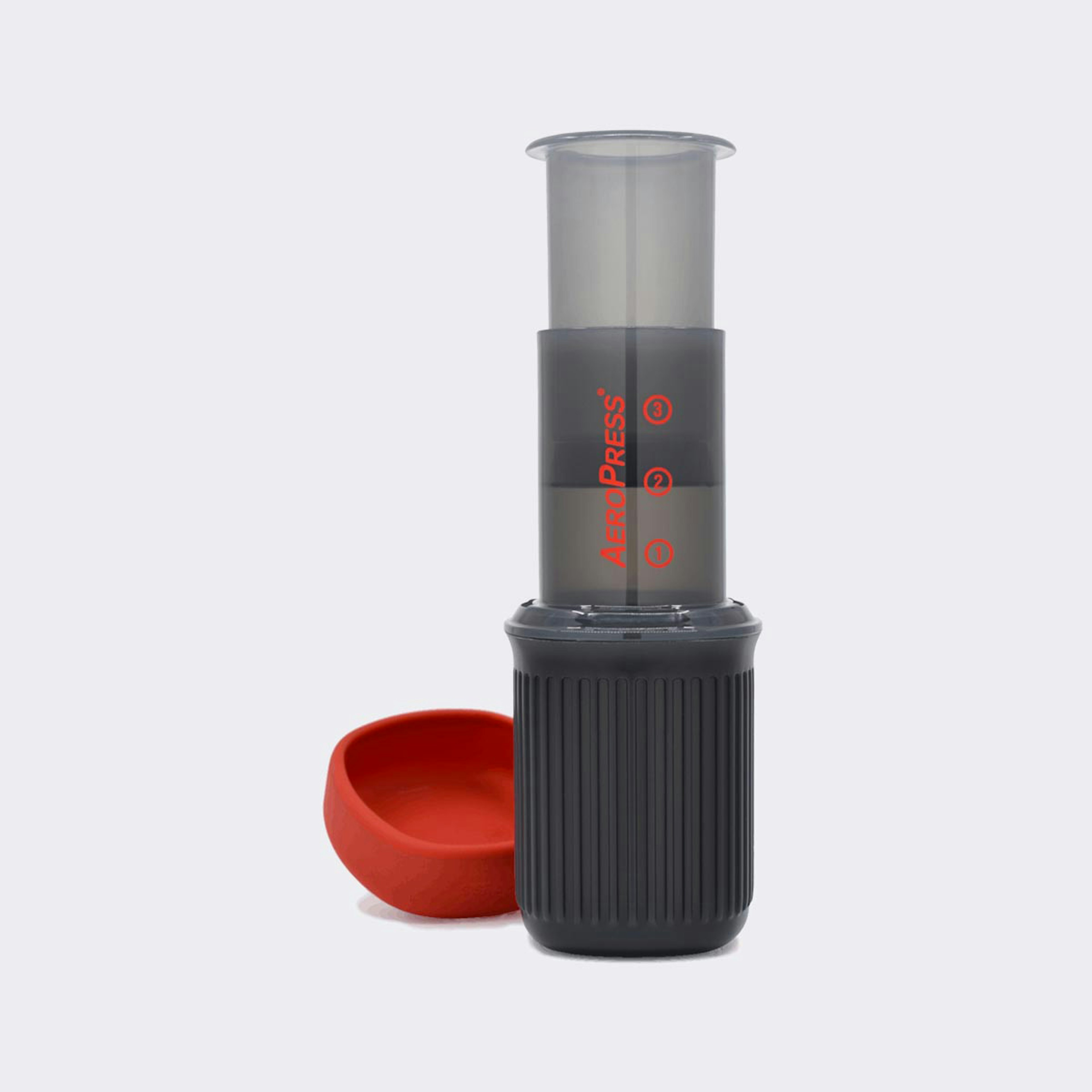 A grey and red AeroPress Go travel coffee press