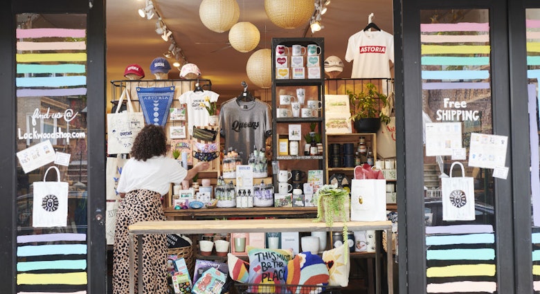 An employee adjusts face masks displayed for sale in an open window for curbside pickup at a Lockwood store in the Astoria neighborhood in the Queens borough of New York, U.S., on Friday, June 5, 2020. For New York's small businesses, which depend almost entirely on city residents, Monday marked a vital moment to start bringing in the customers and revenue they lost during the shutdown an undertaking all the more precarious with the current social unrest. Photographer: Gabby Jones/Bloomberg via Getty Images