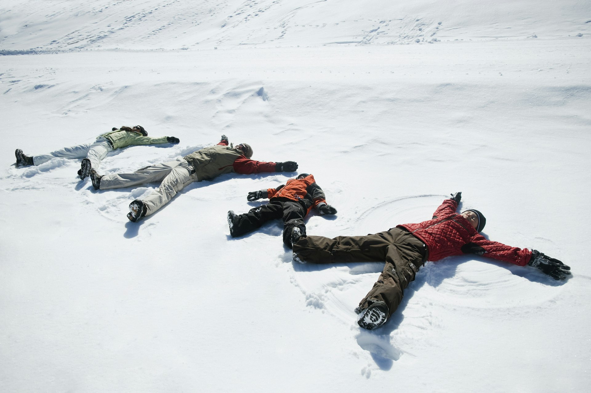 Family making snow angels