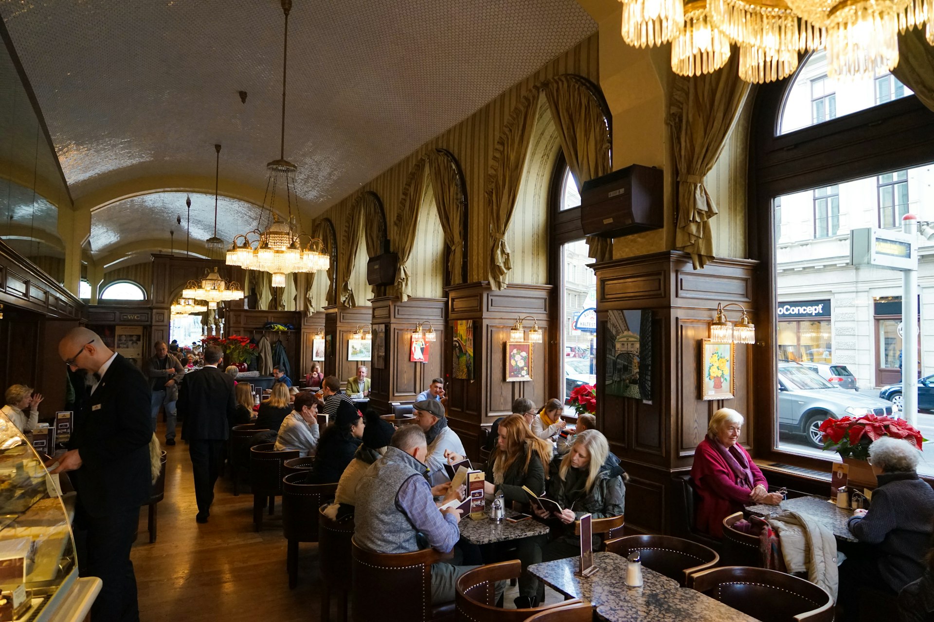 People sipping coffee in Cafe Schwarzenberg in Vienna