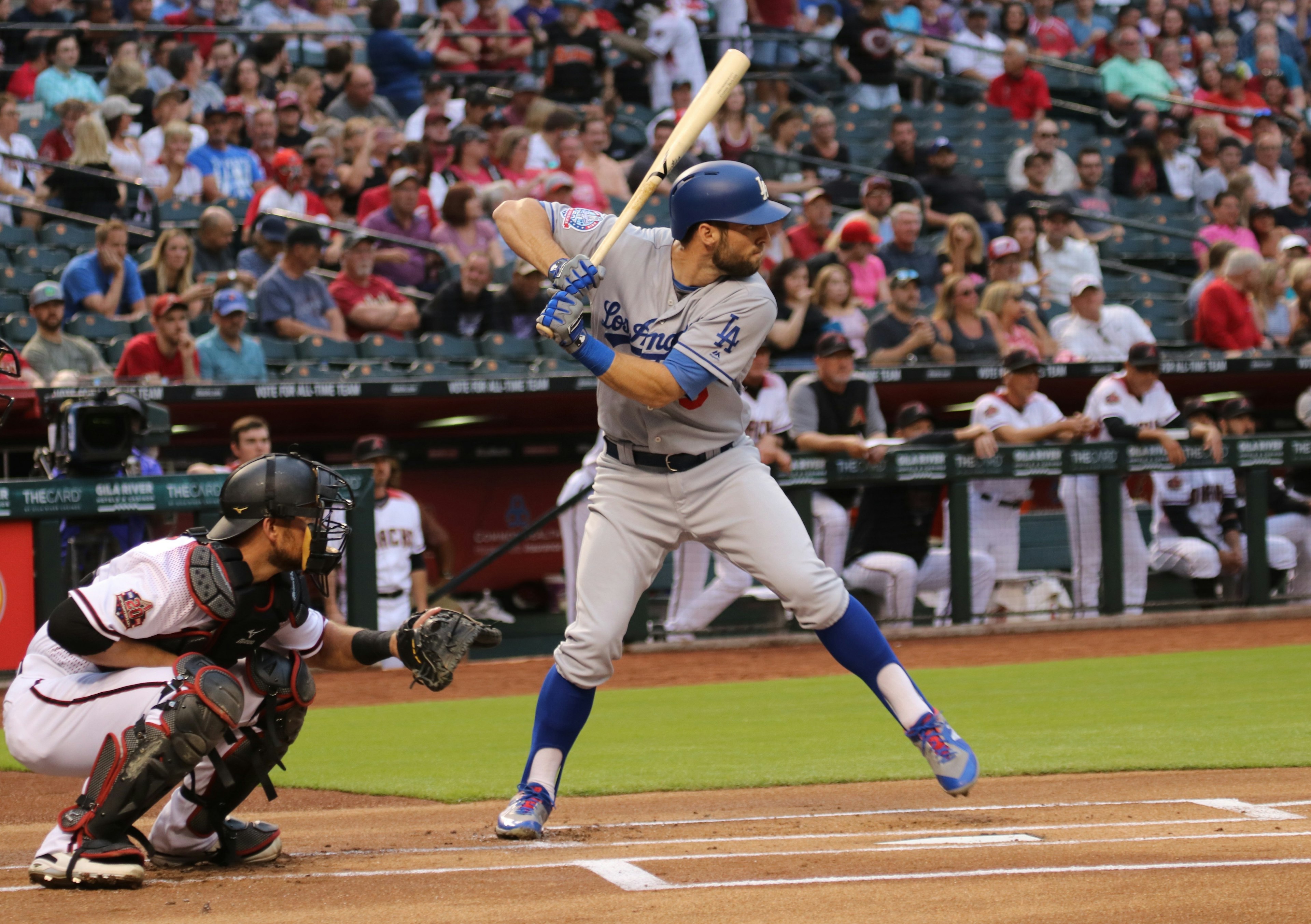 A baseball player takes a strike at Chase Field in Phoenix Arizona