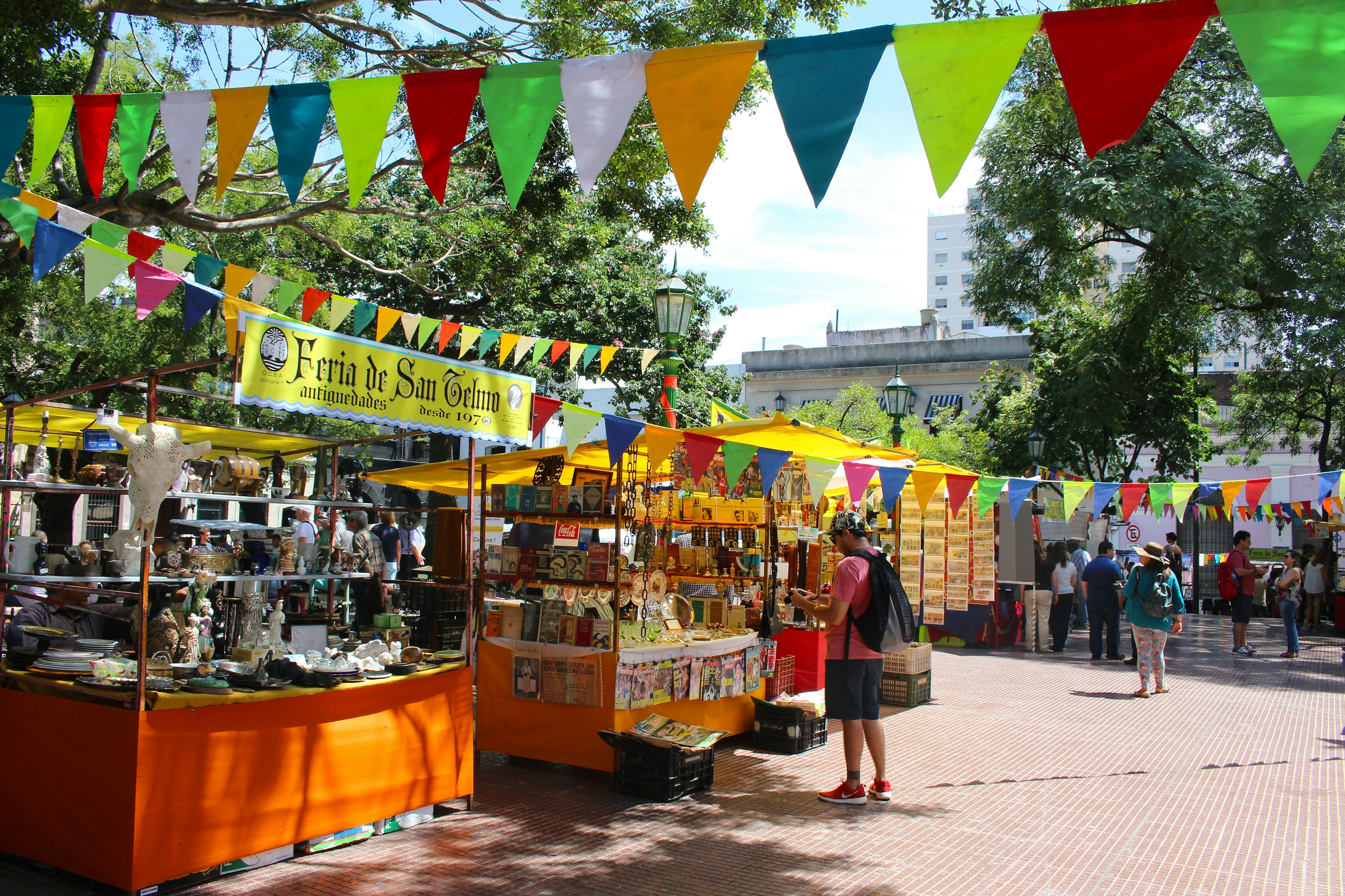 People browse at stalls at an antique market during Feria de San Pedro Telmo in Buenos Aires