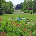 MAY 19, 2018: Visitors resting and playing in Sempione Park during the late afternoon.