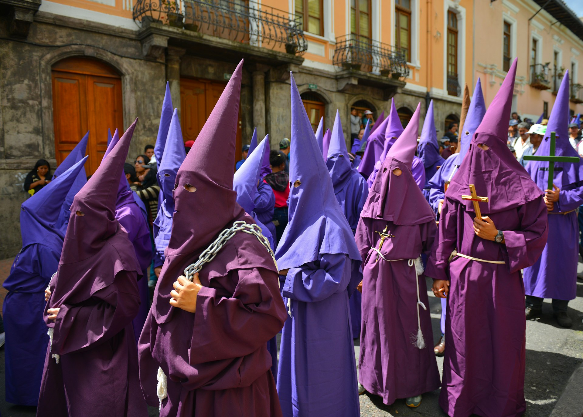 Celebrants in hooded robes parade in Quito for Easter