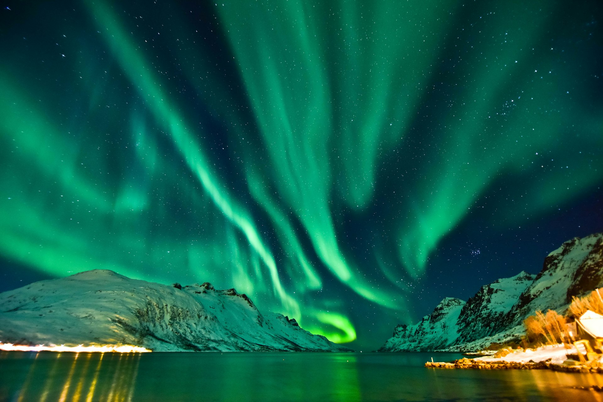Aurora Borealis in Tromso, Norway in front of the Norwegian fjord, winter season