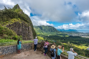 Nu'uanu, Hawaii, Oahu - May 28, 2017: tourists and island visitors gaze at the view of the winward side of oahu from the pali lookout, a section of the windward cliff of the Ko'olau mountain range