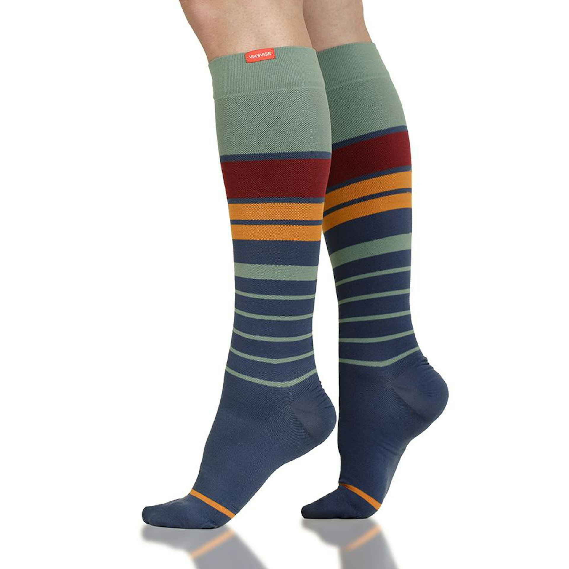 A person's legs seen from the knees down, wearing green, yellow and red–striped compression socks