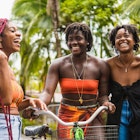 Stock photo of happy female friends laughing and talking in the streets of Costa Rica.