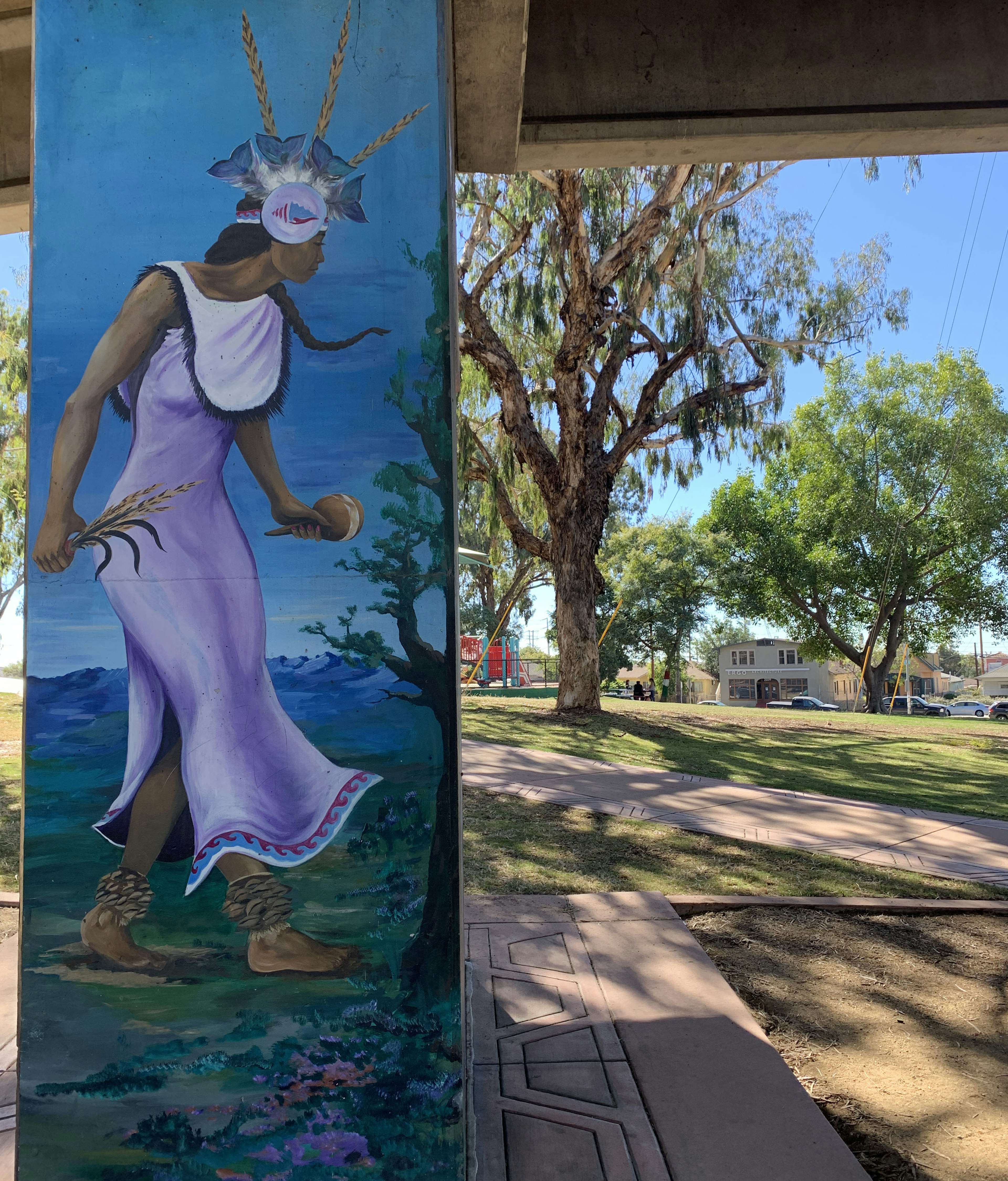 Image of a woman wearing traditional Mexican clothing and headdress is etched on a concrete underpass in Chicano Park in San Diego's Barrio Logan.