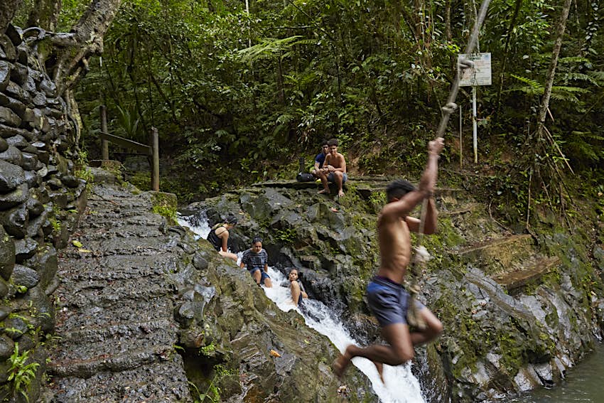 Local people using the rope swing and swimming hole in Colo-I-Suva Rain Forest