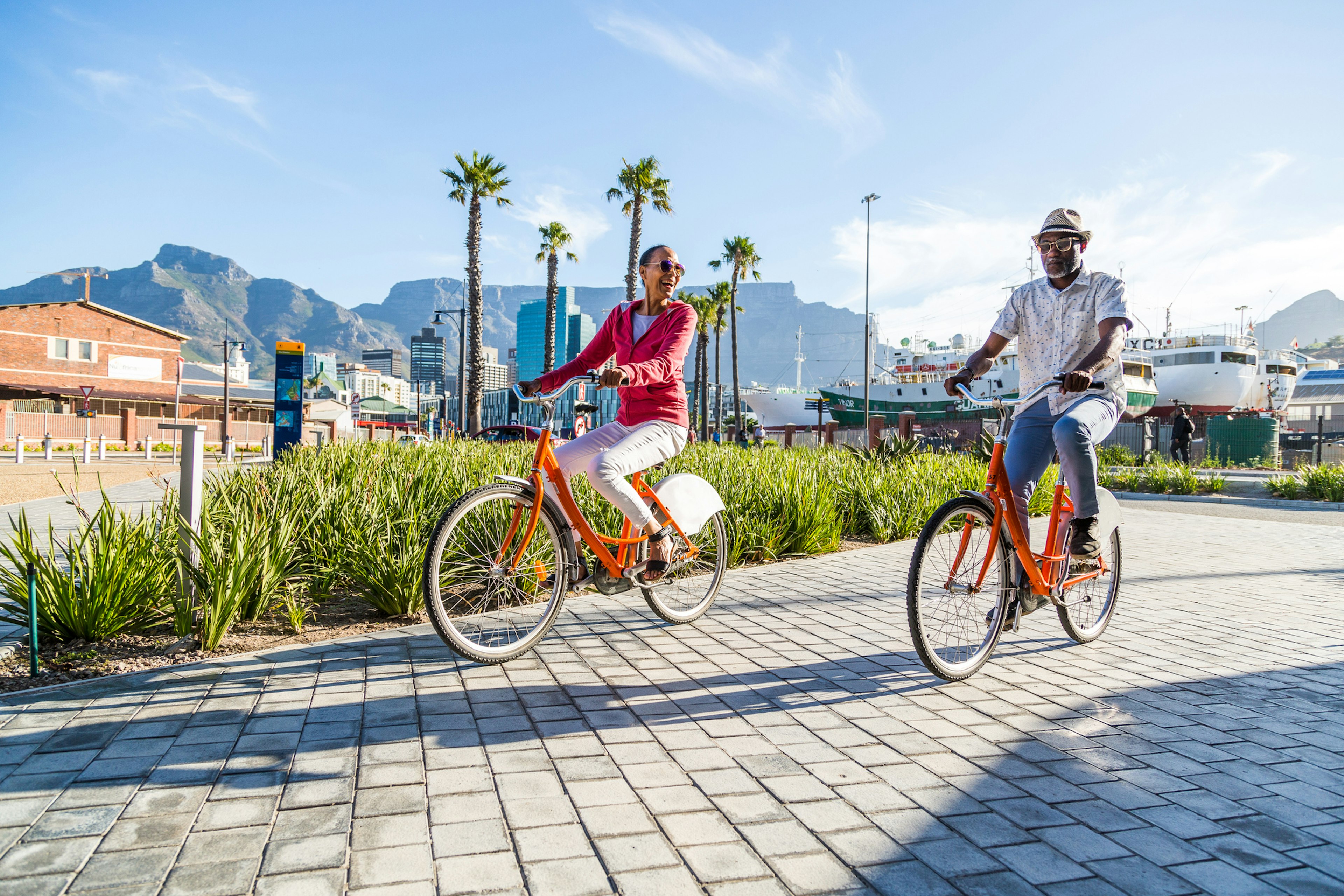 Couple sightseeing on hired bicycles in city