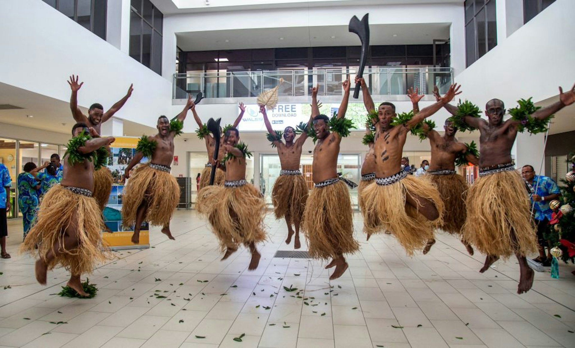 Traditional dancers in grass skirts welcome holidaymakers in Nadi on December 1