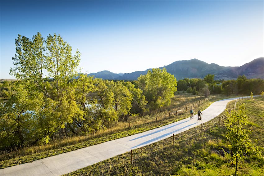 Cyclists pedal in afternoon sunshine near Boulder