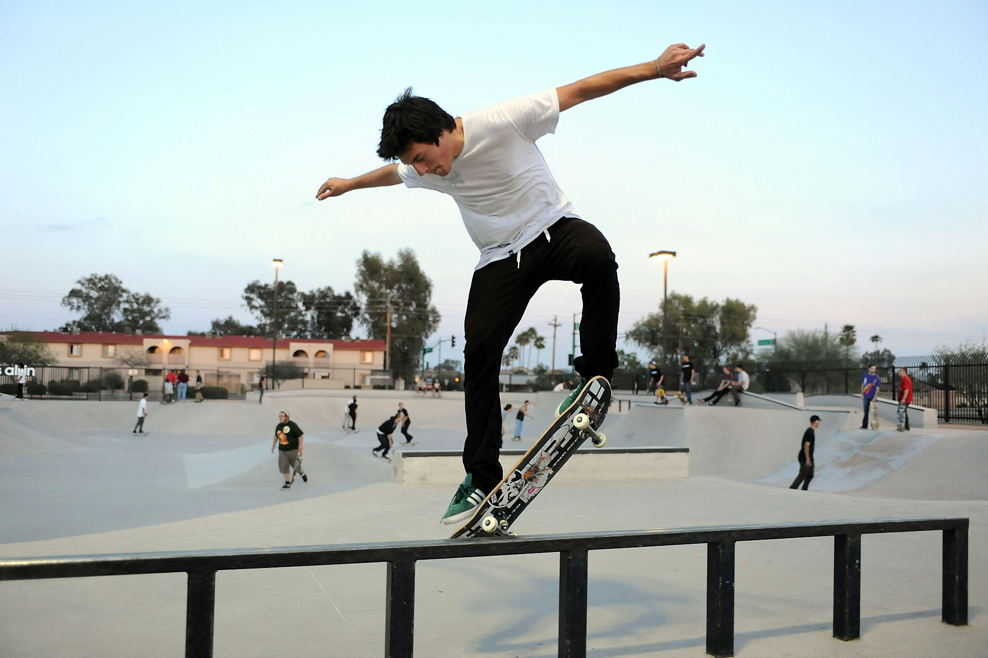 A skateboarder slides his board across a rail at Paradise Valley Skate Park