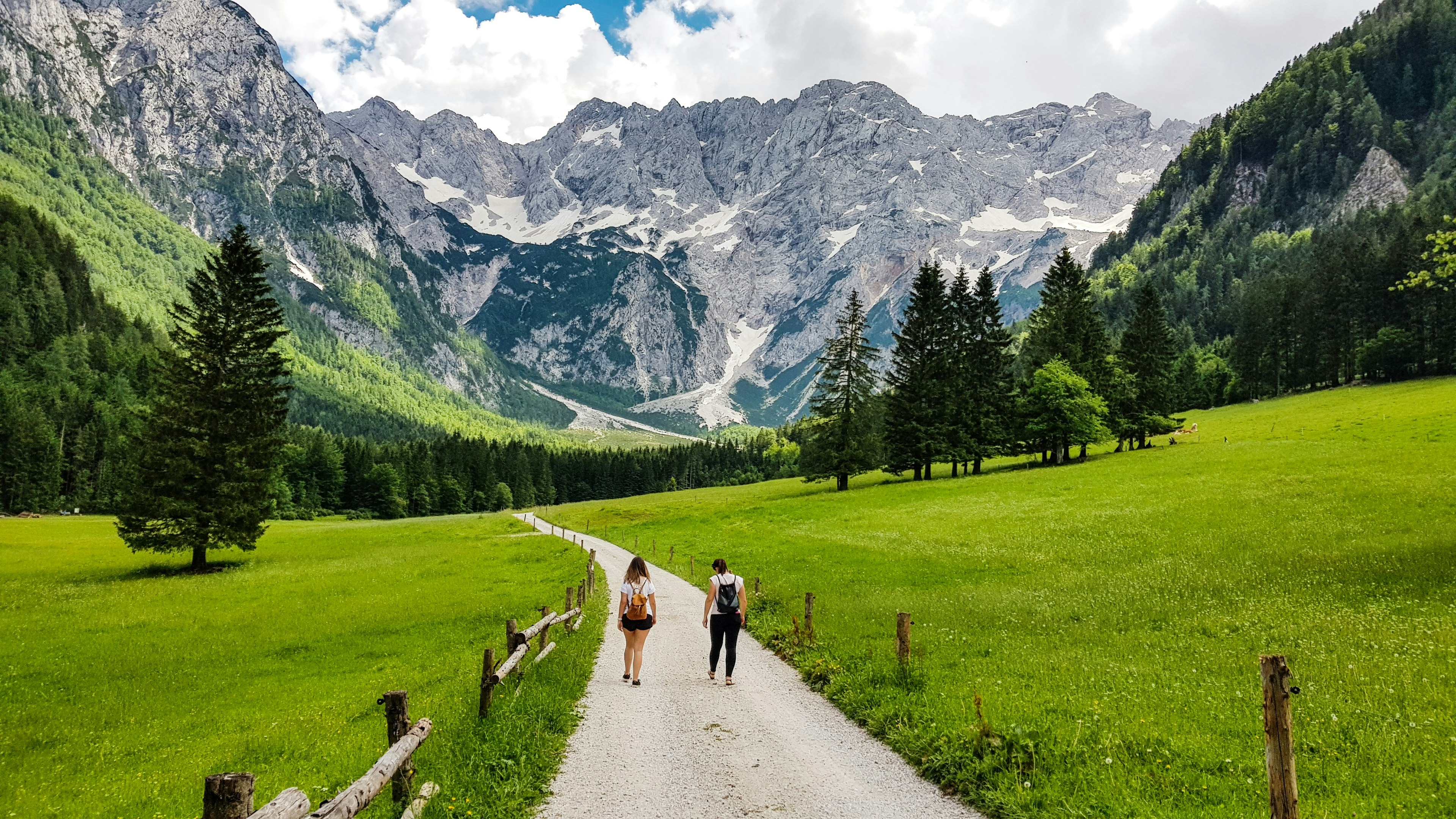 Rear View Of Two Women Walking On Footpath Leading Towards Mountain - stock photo
Photo taken in Zgornje Jezersko, Slovenia