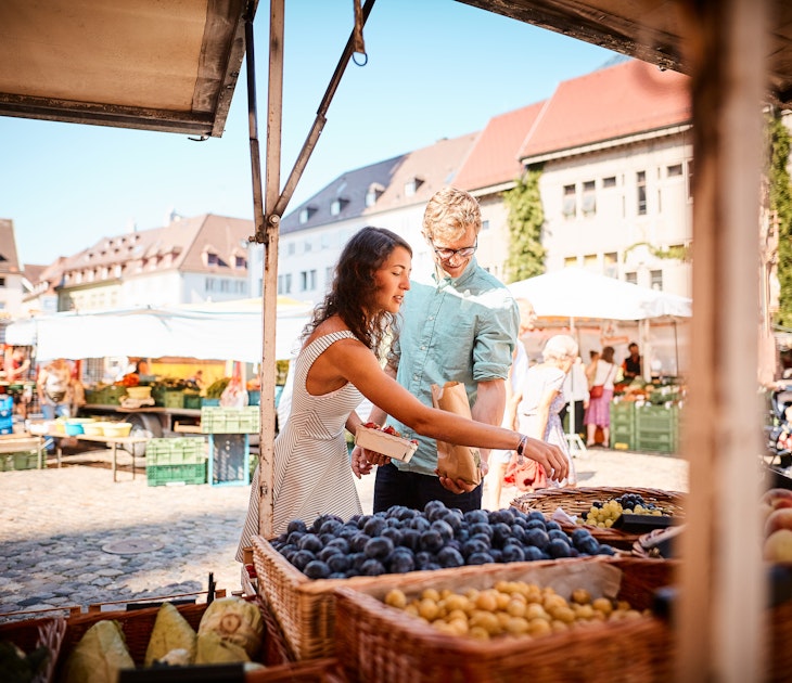 Couple shopping at an open-air market in Freiburg, Germany