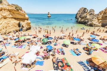 Tourists sunbathing in Praia do Camilo, Lagos, Faro district, Algarve, Portugal