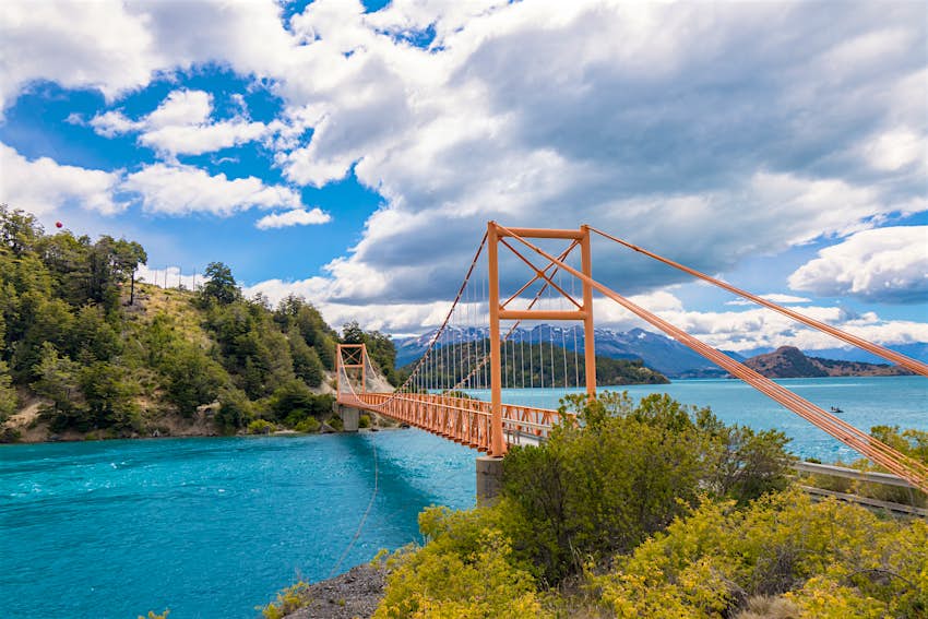 A short red road bridge over turquoise glacial lakes