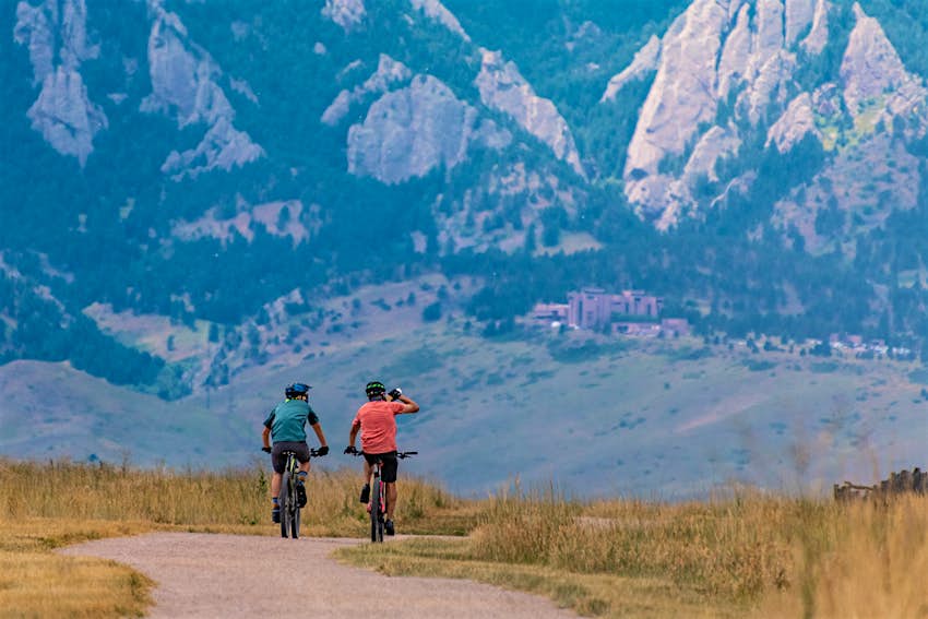 Two cyclists riding through the Boulder Valley early in the morning 