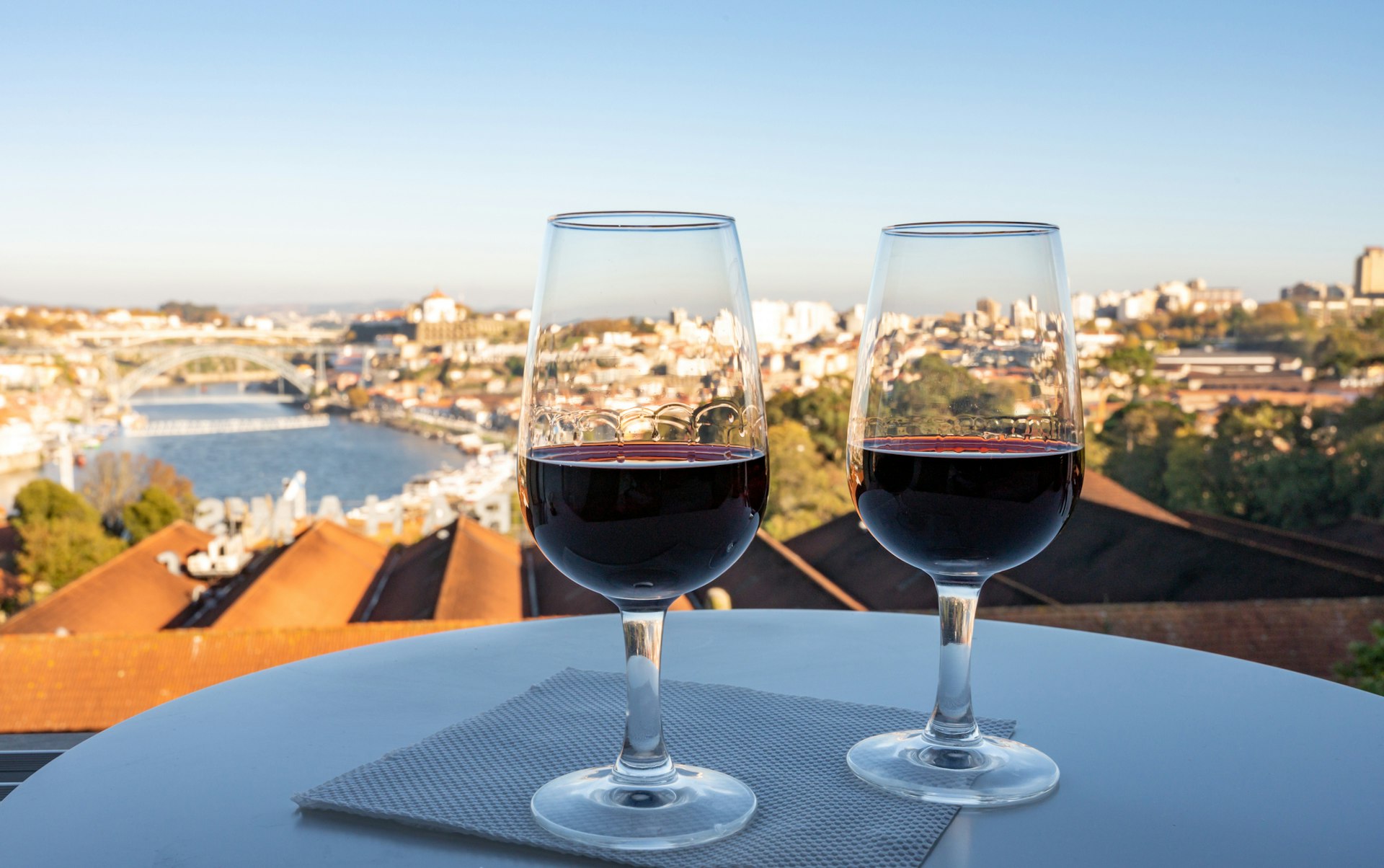 Two glasses of port on a table with a view over the Douro river
