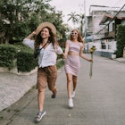 Two lesbians walking down the street holding hands. Summertime