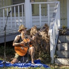 Athens, Georgia - October 10, 2021: Acoustic trio, Greenheart, plays in the front yard of a house in Newtown during Porchfest, a celebration of the city's historic neighborhoods.