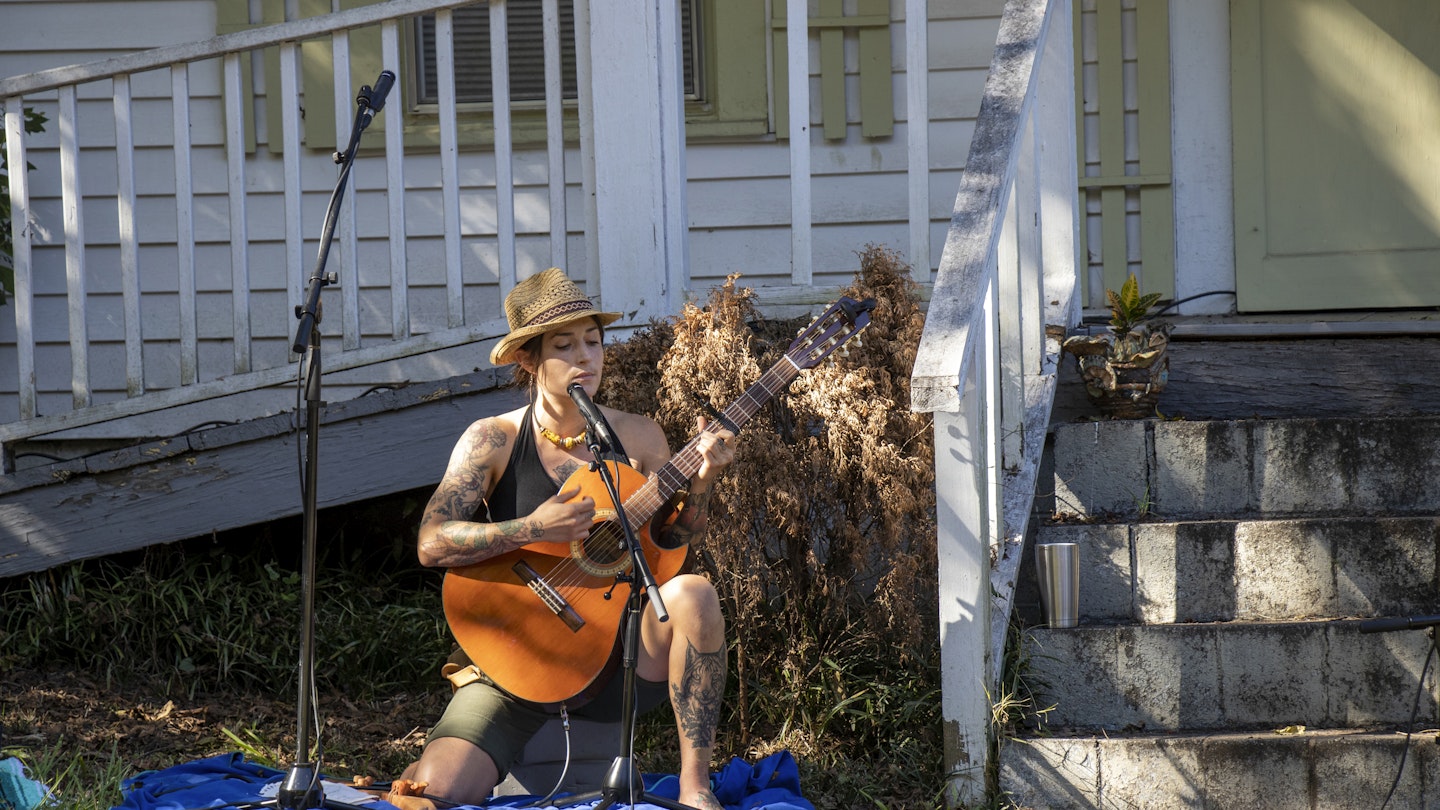 Athens, Georgia - October 10, 2021: Acoustic trio, Greenheart, plays in the front yard of a house in Newtown during Porchfest, a celebration of the city's historic neighborhoods.