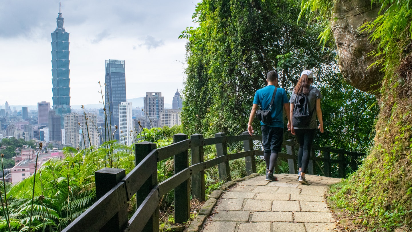 Couple Hiking on Forest Path and Taipei Skyline in Background - Taipei, Taiwan