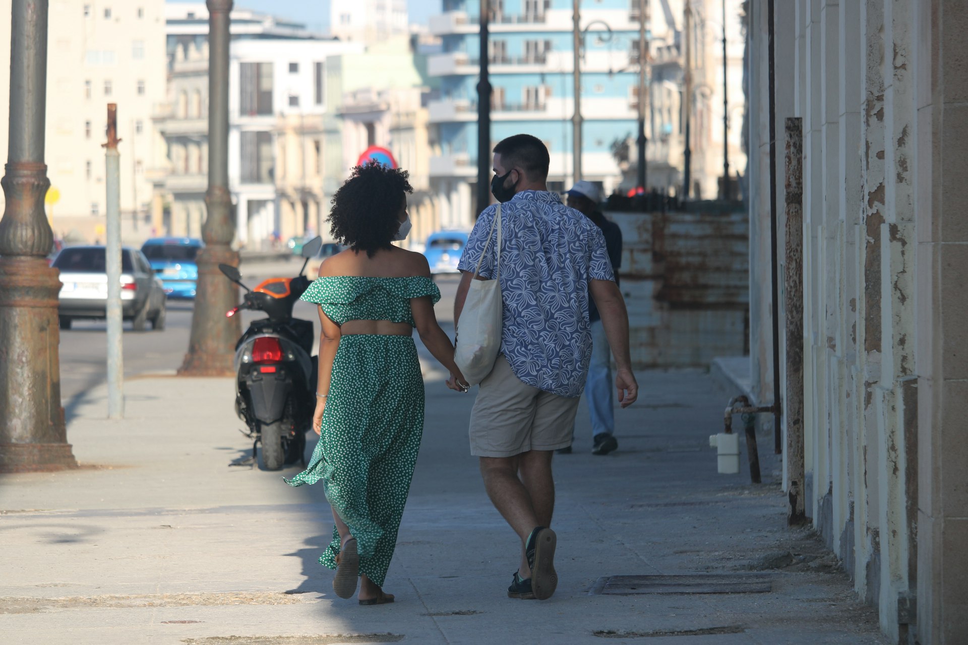 A couple adheres to the mask mandates on the streets of Havana